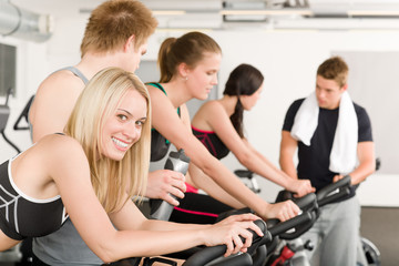 Fototapeta na wymiar Fitness group of people on gym bike