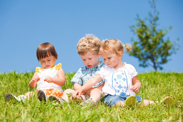 Kids sit on grass