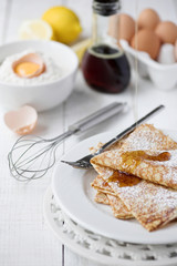 Freshly prepared crepes with maple syrup