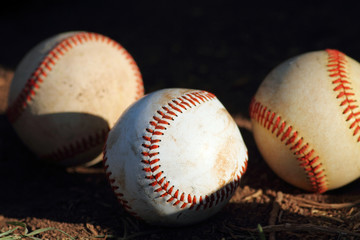 three baseballs in sun