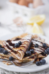 Freshly prepared crepes with blueberries & chocolate sauce