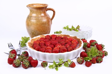 Strawberry Tart, plates, a pot, strawberries and mint twigs