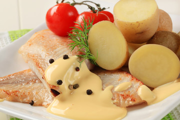 Pan fried fish fillets and potatoes