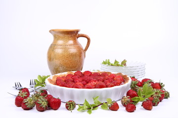 Strawberry Tart, plates, a pot, strawberries and mint twigs