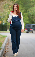 pregnant woman walking on street