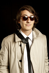 fashion young man with sunglasses and trenchcoat