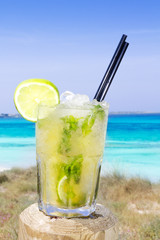 Cocktail mojito ice lemon straws in tropical beach