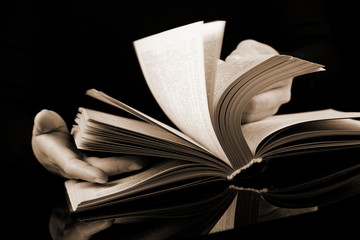 Book with motion blur on black background