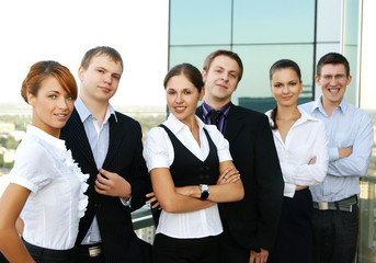 Six young businesspersons in formal clothes standing in a row