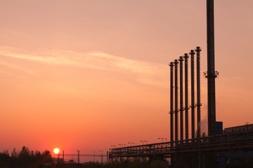 Factory chimneys at sunrise