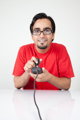 Geek playing old video game with controller in hand © Haider Azim