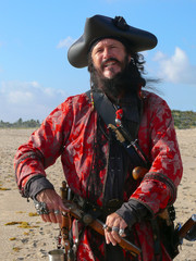 Pirate with weapons on the beach