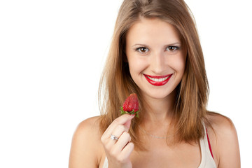 Close-up portrait of young female going to eat strawberry