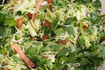Fresh raw vegetables salad with olive oil close-up