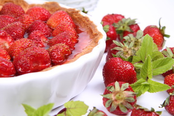 Strawberry Tart decorated with strawberries and mint twigs
