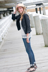 Fashion girl on wooden jetty by the sea