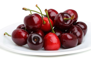 Ripe cherries on a white plate