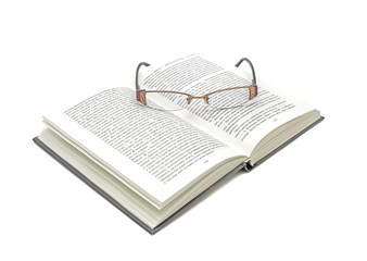open book and glasses on a white background