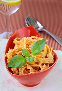 Italian pasta tripoline with tomato sauce and basil