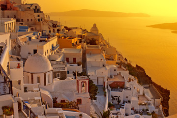 Sunset at Santorini island , Greek church with a cross