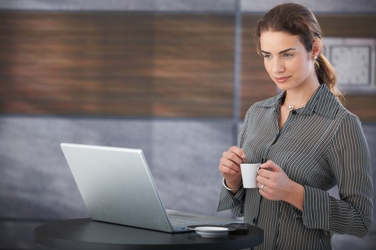 Young businesswoman drinking coffee