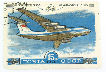 A vintage canselled stamp with a plane