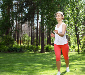 Young girl in a white shirt and red pants