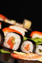 Delicious sushi on black background