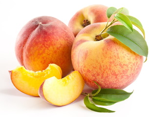 Ripe peach fruit with leaves and slises