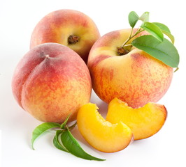 Ripe peach fruit with leaves and slises
