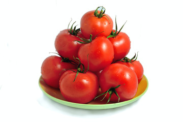 the fresh tomatoes isolated on a plate