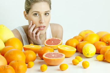 portrait of young woman with citrus fruit