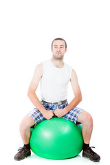 Young guy on a exercise ball