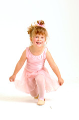Little smiley girl wearing a pink ballet outfit