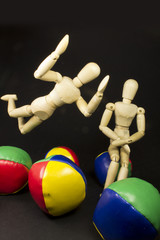 humanoid couple jumping on balls of many colors