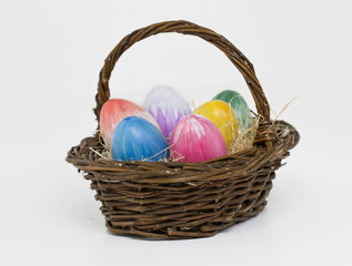 Basket with eastereggs on white background