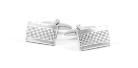 A pair of silver cuff links isolated on a white background.