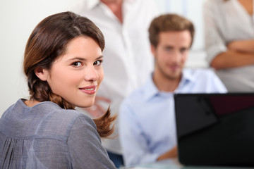 Young woman with male colleagues