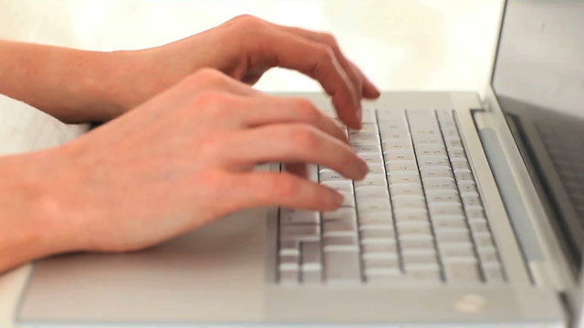Woman's hands typing on a computer