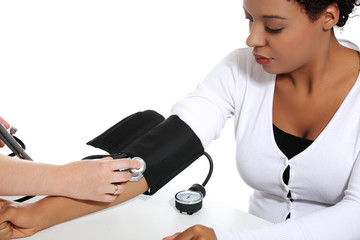 Doctor checking blood pressure of pregnant woman.