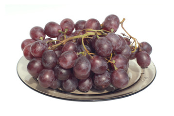 Red wine grape branch on transparent plate isolated on white