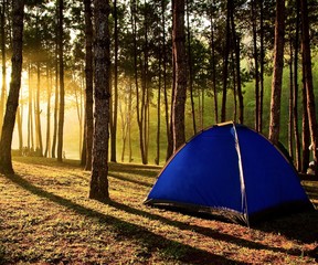 People to extend a tent on the hill to watch sunset.