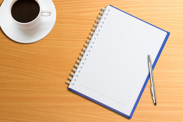 Notebooks, pens, coffee on the table