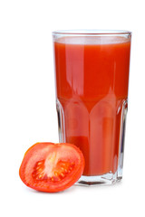 Drinking glass with tomato juice and ripe fresh tomato near