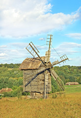 Fototapeta premium Antique ramshackle wooden windmill, Pirogovo, Kiev, Ukraine