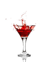 red martini cocktail splashing into glass