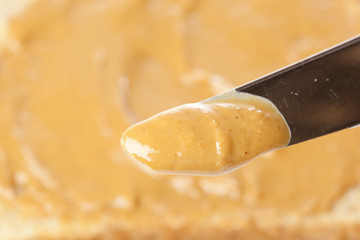 A knife with peanut butter on it