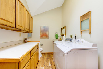 Large laundry room with white washer and dryer