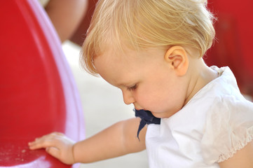 Little girl in white suit in park