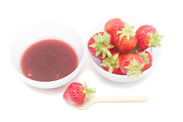 Bowl with strawberry jam isolated on white